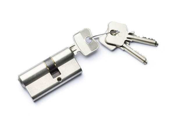 Used door lock assembly and new keys on white background