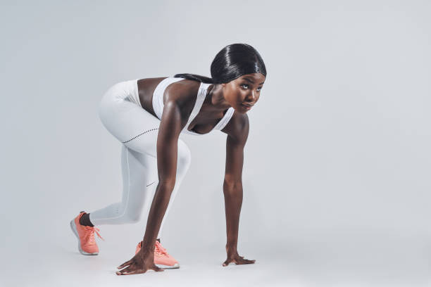 istock Beautiful young African woman standing at starting position 1336678111