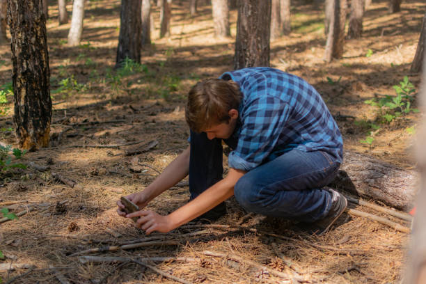 istock Young man with backpack on his back, walking through the pine wood forest, exploring, hiking and enjoying the nature and the view, relaxing. 1336678524