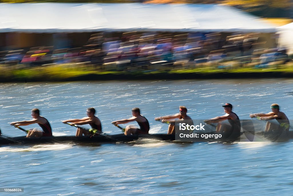 Teamwork Speeding rowing boat with motion blur to accent speed. Sport Rowing Stock Photo