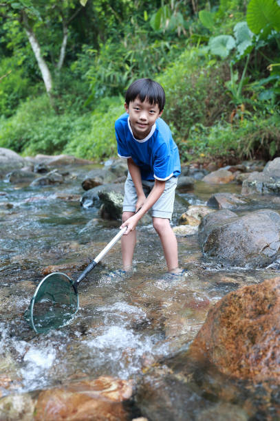istock Boys fishing in stream 1336684550
