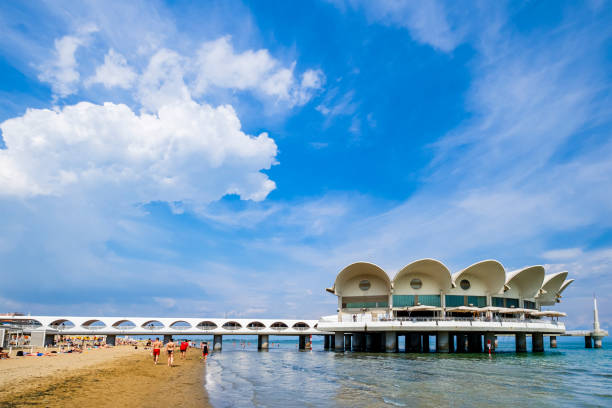 People enjoying a sunny day on the beach of Lignano Sabbiadoro, a  summer tourist spot on the Adriatic see coast.