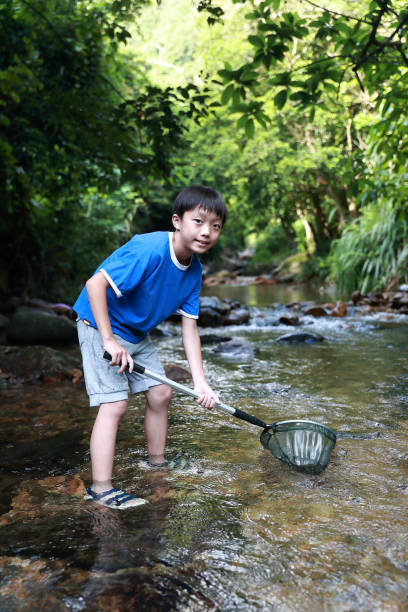 istock Boys fishing in stream 1336684773