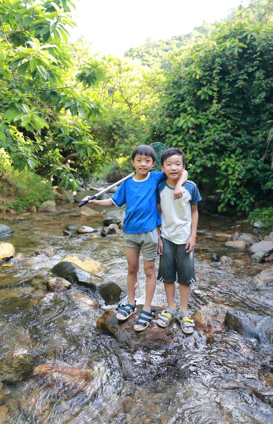 istock Boys fishing in stream 1336684805