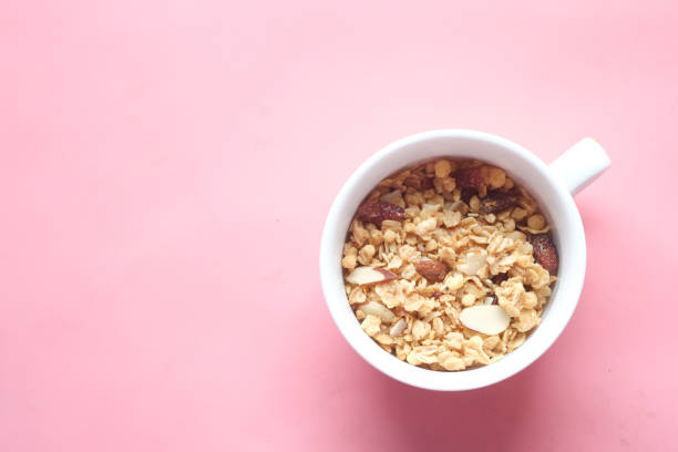 cereal breakfast in bowl on pink background .