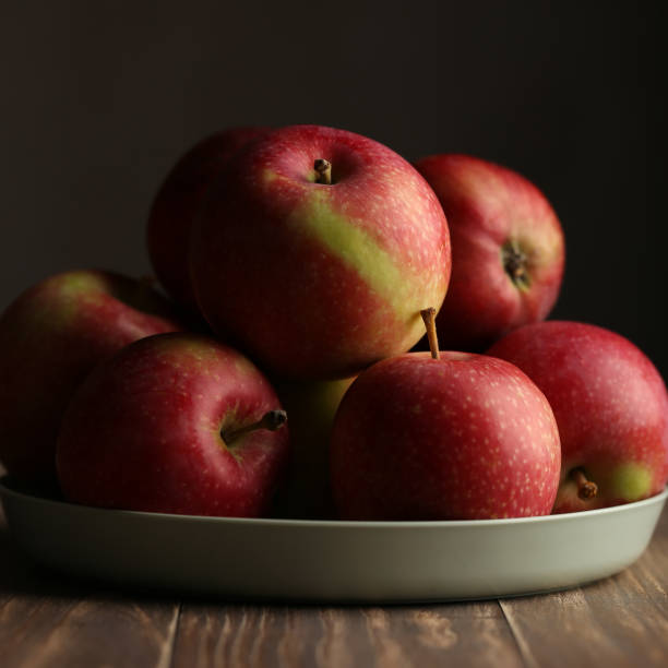 istock Apples on plate, red and green apples 1336686649