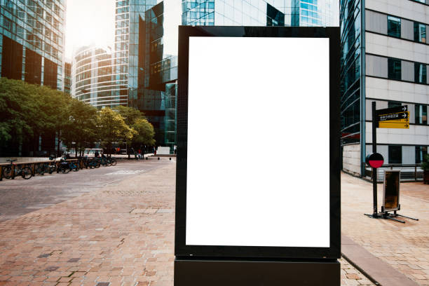 istock Blank billboard surrounded by office buildings - copy space on white background for edit 1336687530