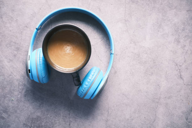 istock top view of coffee mug and headphone on black background . 1336688134