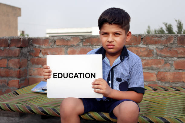 istock School student holding white paper in hand with writing Education on it 1336688821