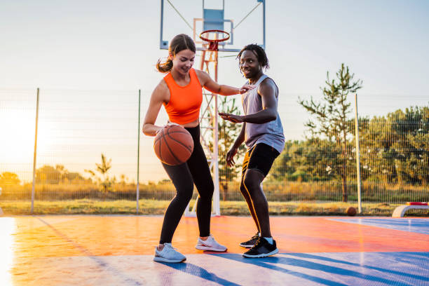 istock Couple enjoying basketball match 1336688960