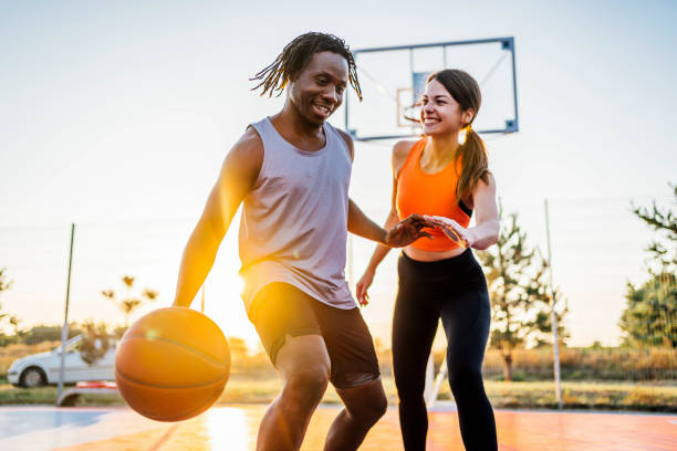 istock Cheerful couple playing basketball 1336689073