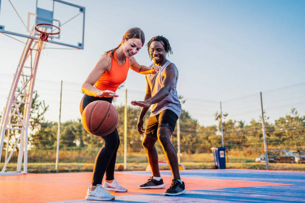 istock Couple enjoying basketball match 1336689345