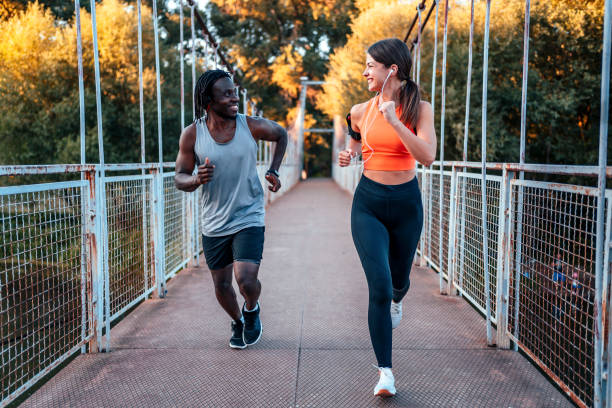 istock Athletic couple running together 1336689577