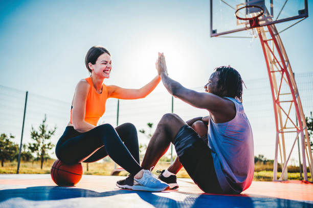 istock Couple at basketball court doing high five 1336689647
