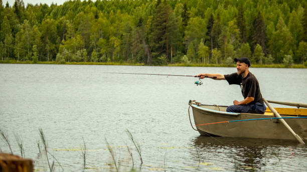 istock bearded man fishing on a spinning boat 1336690161