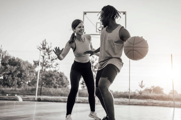 istock Cheerful couple playing basketball 1336690282