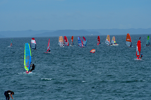 Many young people are enjoying windsurfing on a fine, windy Sunday afternoon at Miura Beach, Miura City, Kanagawa Prefecture. Miura Beach is located at the entrance to Tokyo Bay from the Pacific Ocean.