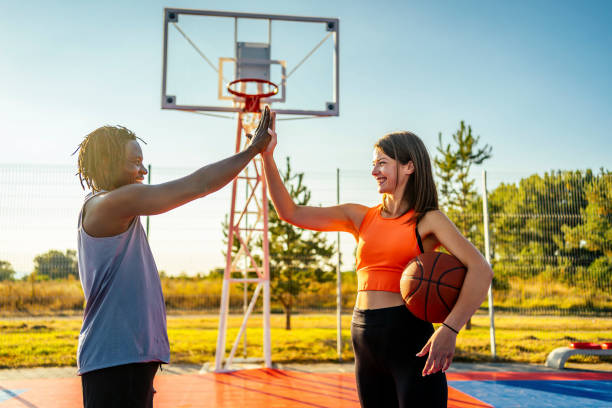 istock Couple at basketball court doing high five 1336690787