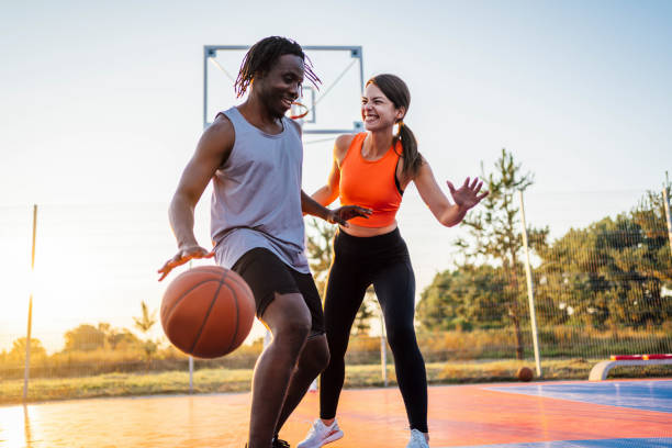 istock Cheerful couple playing basketball 1336690950