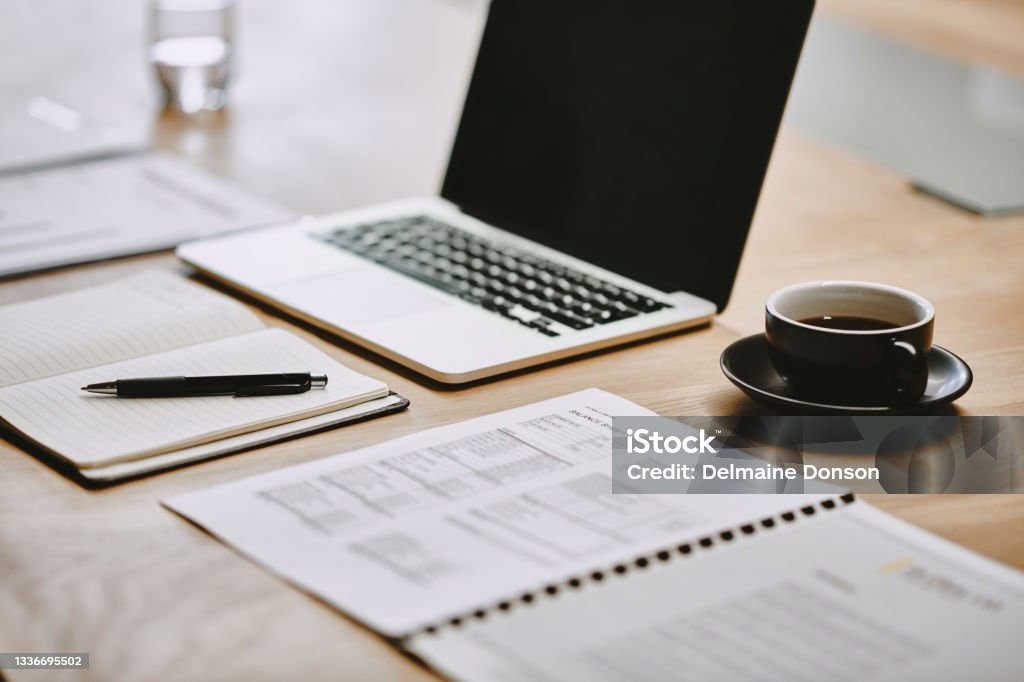 Shot of a notebook and laptop in an office There's a busy day ahead Desk Stock Photo