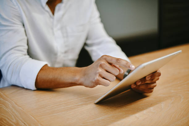 istock Shot of an unrecognizable businessperson using a digital tablet at work 1336695568
