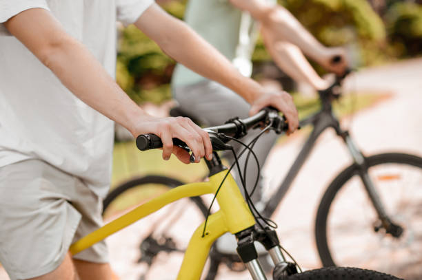 istock Two Caucasian athletes biking together in a park 1336695625