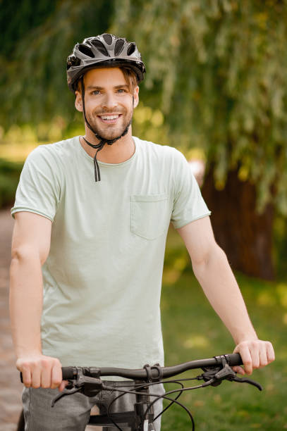 istock Smiling happy sportsman in protective headgear looking ahead 1336695700