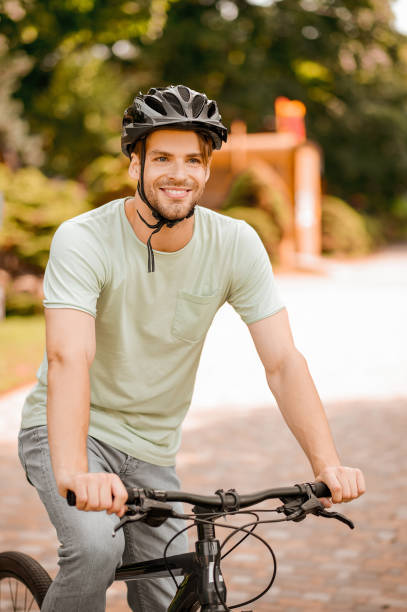 istock Contented bicyclist in a helmet biking alone outside 1336695710