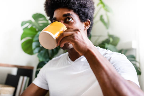 istock Young african american man drinks morning coffee alone at home. 1336696105