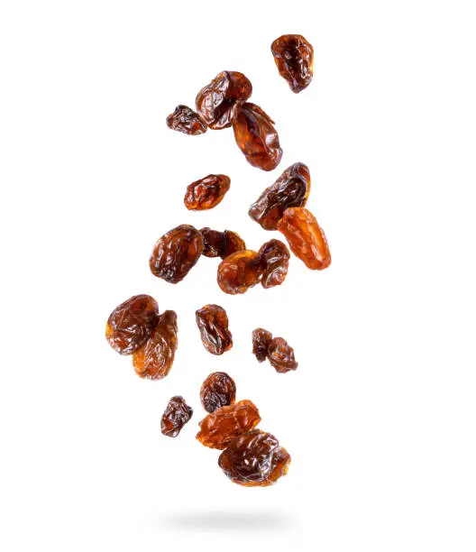 Photo of Delicious raisin in the air isolated on white background