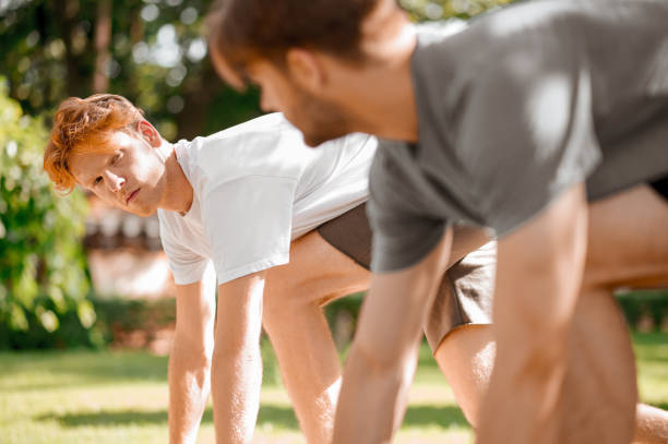 istock Guys at start of sprint looking at each other 1336698276