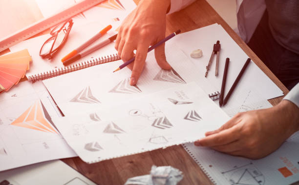 Graphic designer drawing sketches logo design.