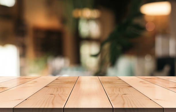 istock Empty wooden table top with lights bokeh on blur restaurant background. 1336699795