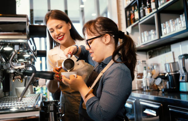 istock Young woman with Down Syndrome working at cafe 1336700328