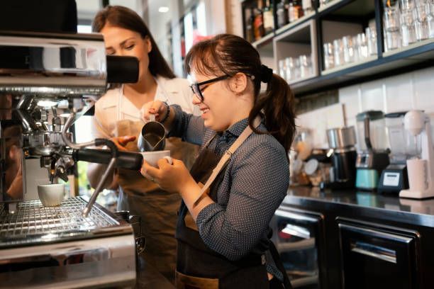 istock Young woman with Down Syndrome working at cafe 1336700338