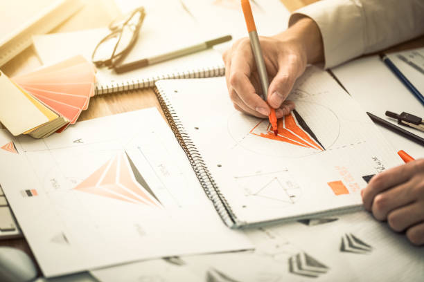istock Graphic designer drawing sketches logo design. 1336700397