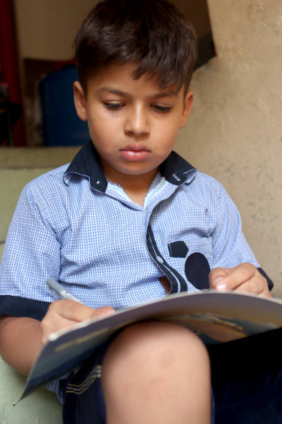 istock 8-9 years schoolboy studying at home during COVID-19, Lockdown period. 1336702574