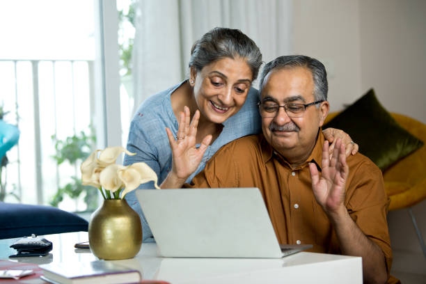 istock Old couple having fun using laptop at home 1336702866