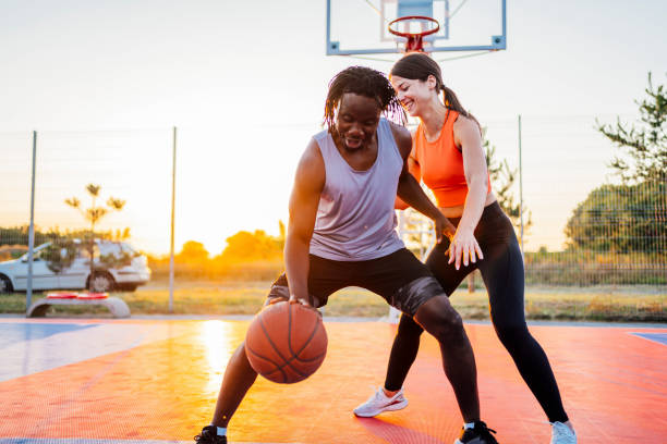 istock Multi-ethnic couple playing basketball 1336703093