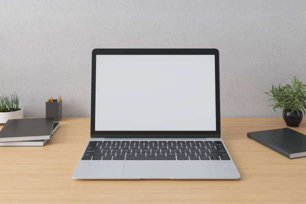 istock Laptop with mockup screen on the table in interior. Mockup. 1336703980