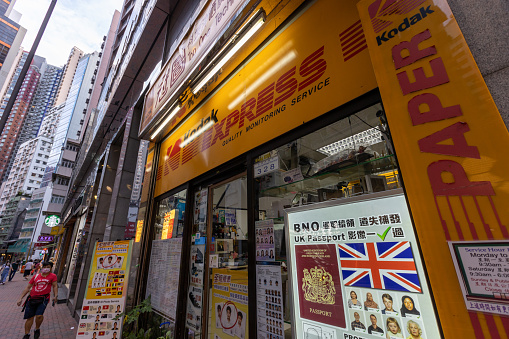 Hong Kong - August 25, 2021 : People walk past the Kodak Express Store in Sheung Wan, Hong Kong. Kodak Express provides photo printing service and selling photo display product in Hong Kong.