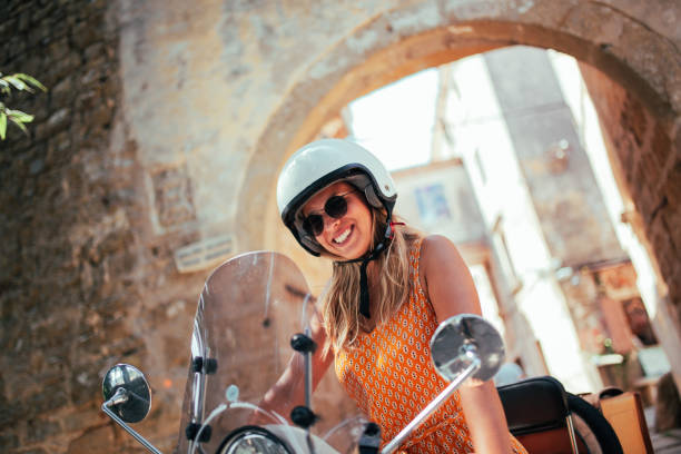 istock Woman and her scooter 1336706116