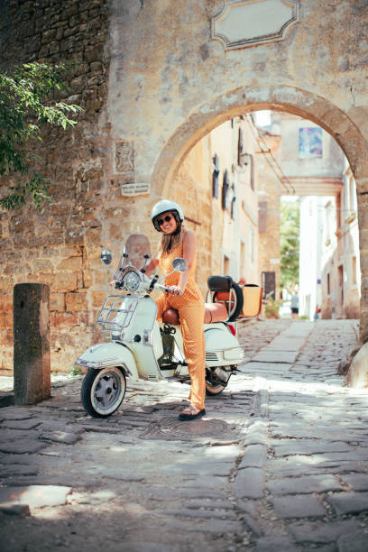 istock Woman and her scooter 1336706120