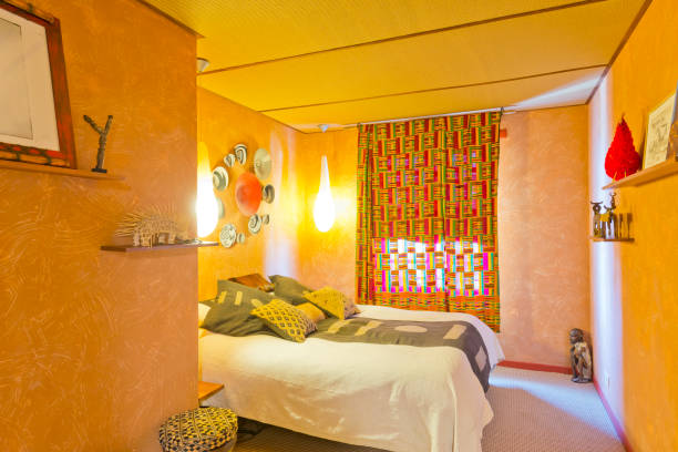 Panoramic image of an elegant bedroom with purple color wall