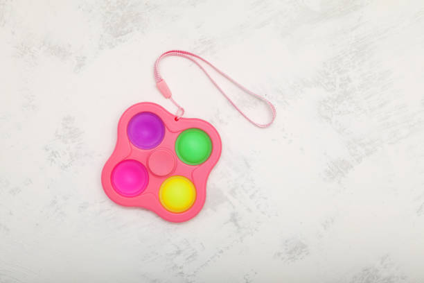 istock Push pop fidget toy (simple dimple, Pop it) on light grey background. Top view, copy space 1336706252