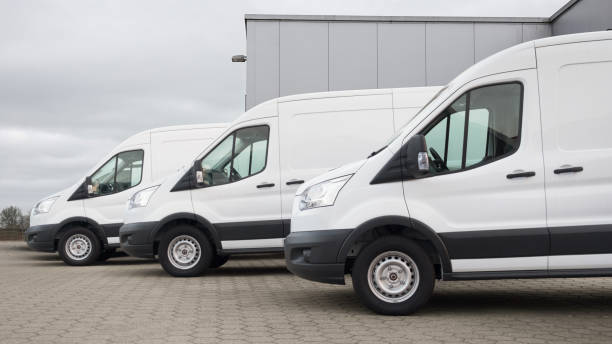 istock White delivery vans with a neutral distribution warehouse in the background 1336706534