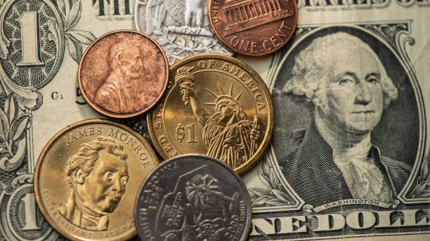 istock One dollar paper bills and coins. 1336707464
