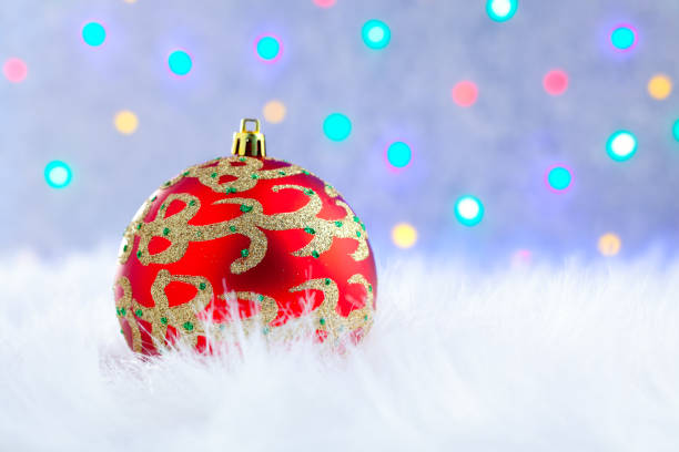 istock christmas bauble on white fur and lights 1336709053
