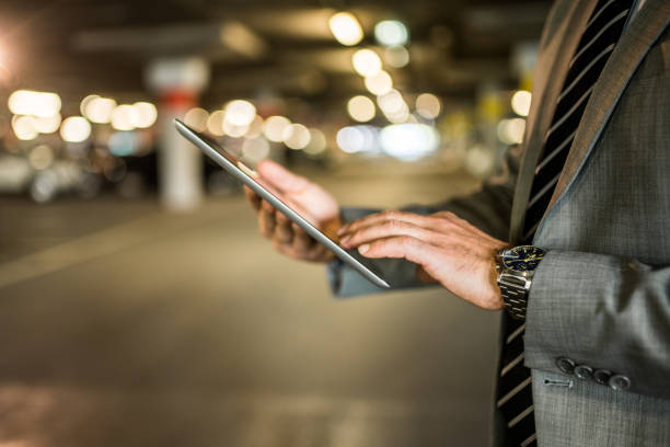 istock Close-up of mature businessman using digital tablet. 1336712089