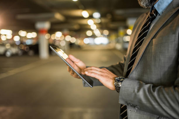 istock Close-up of mature businessman using digital tablet. 1336712134